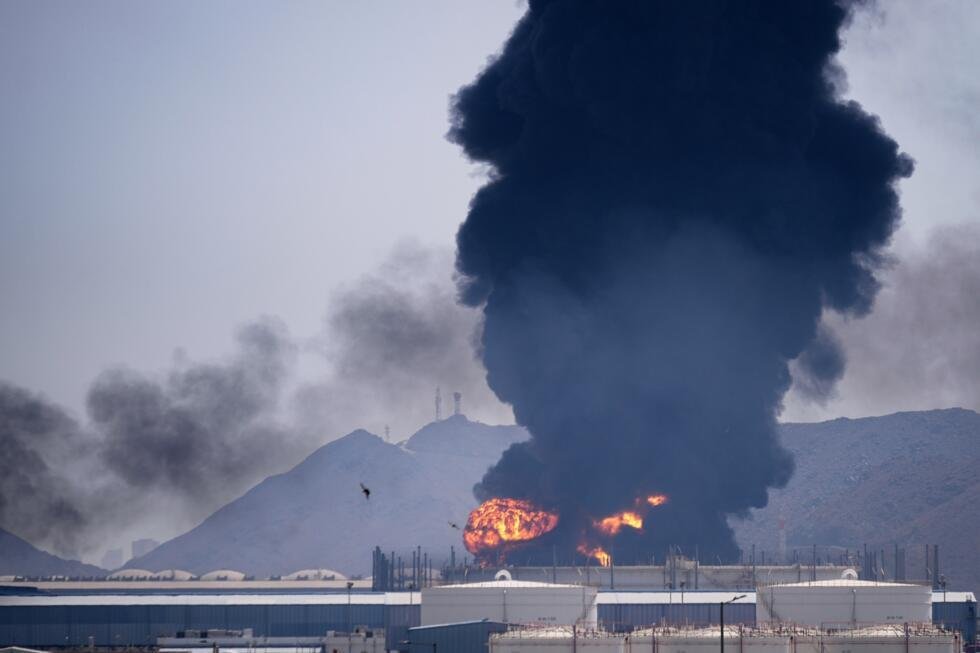 A fire and plume of smoke rise after, according to authorities. debris from an intercepted Iranian drone struck an oil facility in Fujairah, United Arab Emirates, Saturday, March 14, 2026.